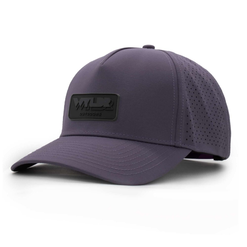 three-quarter view of a 5 panel, water resistant, floatable hat with a PVC patch. the patch is the brand name Wyldr contained in a rounded rectangle. the hat is dark purple.