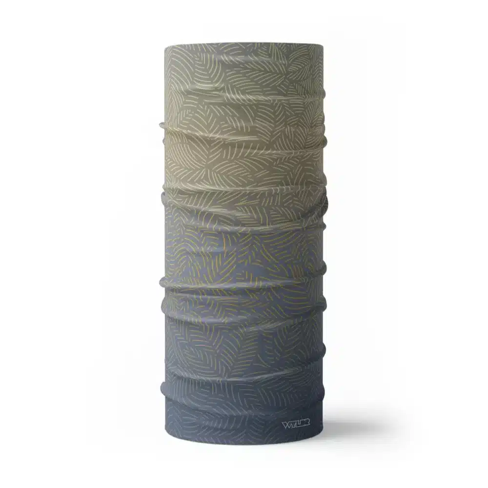 image of a tubular neck gaiter with a crisp leaf pattern overlaid on a gradient background. The colors used in the gradiant are lake, sunflower and dune.
