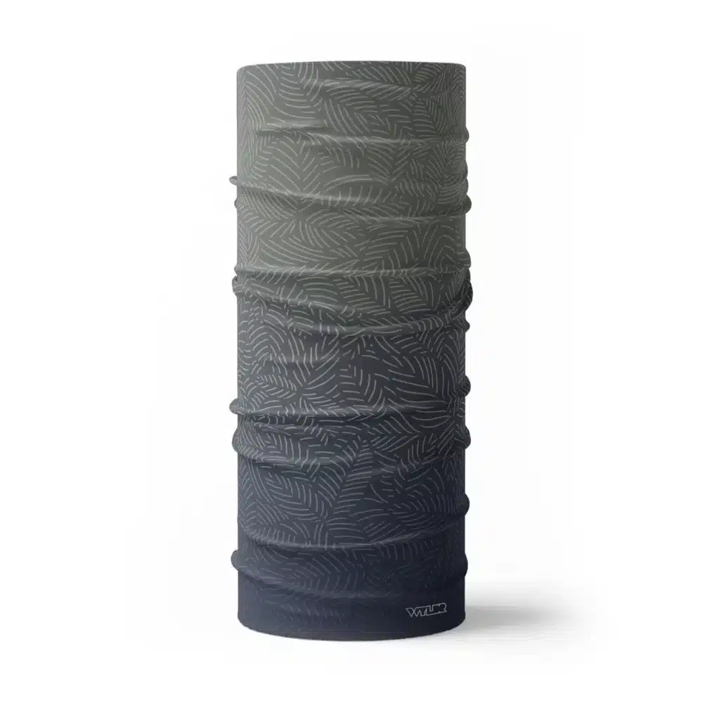 image of a tubular neck gaiter with a crisp leaf pattern overlaid on a gradient background. The colors used in the gradiant are rain, slate and dune.