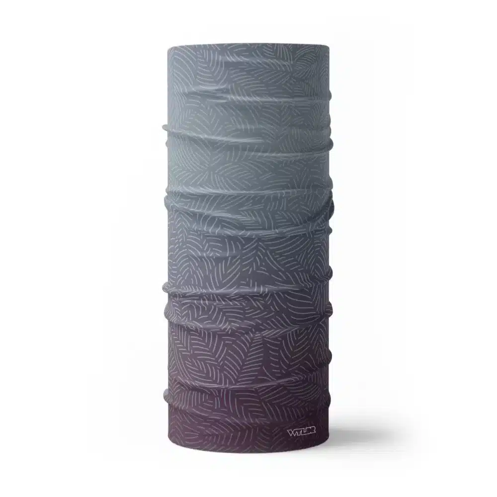 image of a tubular neck gaiter with a crisp leaf pattern overlaid on a gradient background. The colors used in the gradiant are vine, lake and dune.