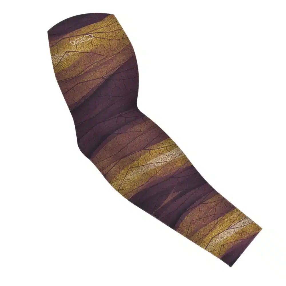 an image of an arm sleeve in an abstract pattern. lines are used to create the illusion the veins that run through leaves. the colors behind it are designed to mimic ocean waves. this is in the cedar/sunflower color variant