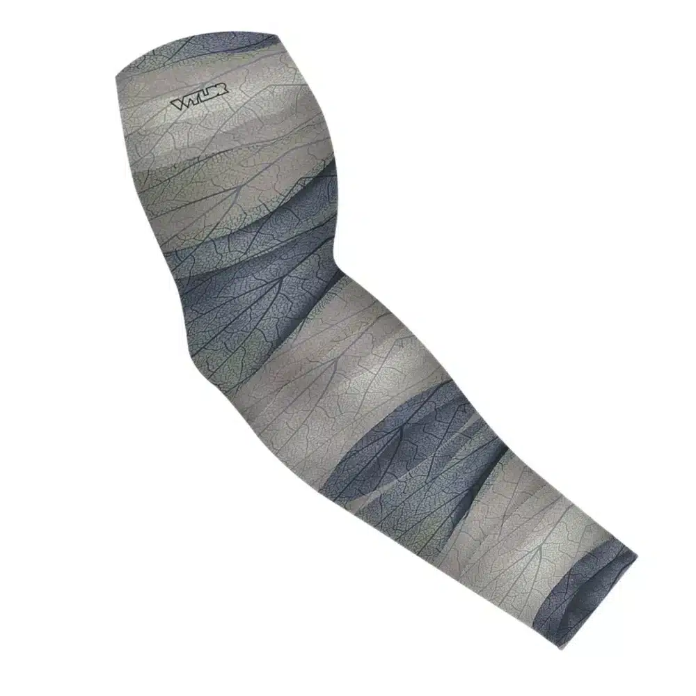an image of an arm sleeve in an abstract pattern. lines are used to create the illusion the veins that run through leaves. the colors behind it are designed to mimic ocean waves. this is in the dune/lake color variant