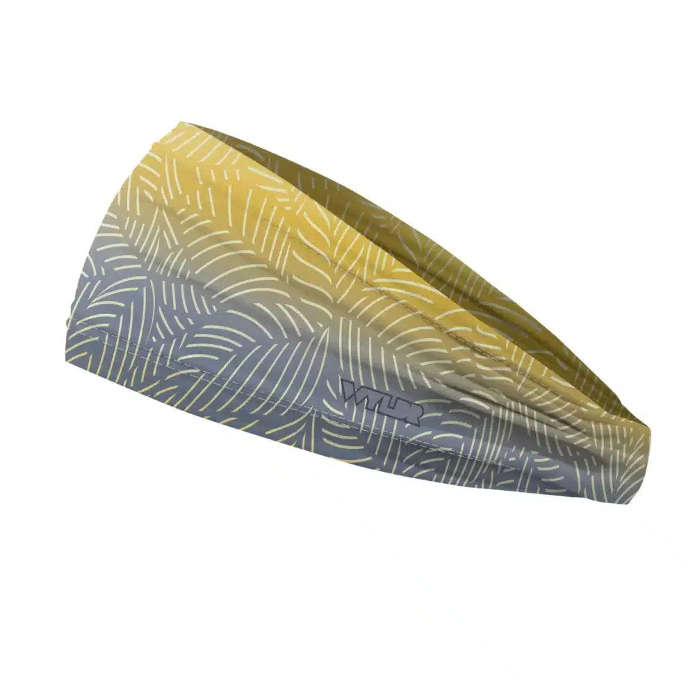 Side view of a headband that is 3 inches at the front and 1 inch in the back to show that it is tapered. This design is an abstract pattern. lines are used to create the illusion of leaves on a gradient color background. this is in the lake/sunflower color variant