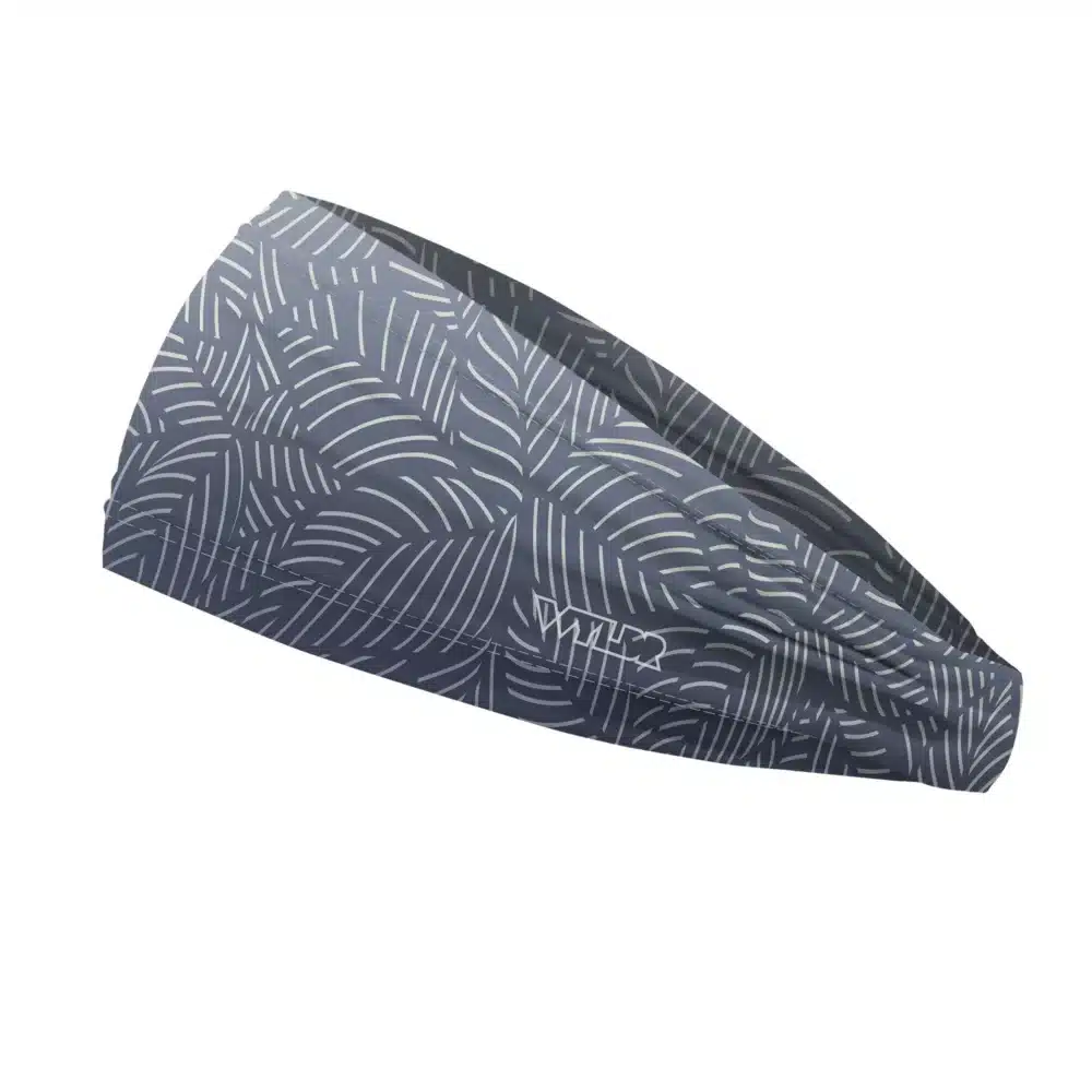 Side view of a headband that is 3 inches at the front and 1 inch in the back to show that it is tapered. This design is an abstract pattern. lines are used to create the illusion of leaves on a gradient color background. this is in the rain/slate color variant