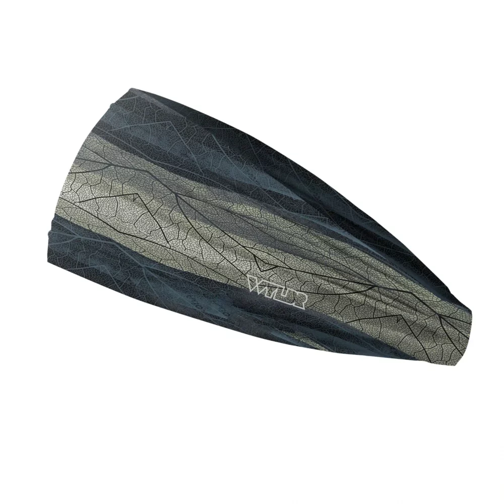 Side view of a headband that is 3 inches at the front and 1 inch in the back to show that it is tapered. The design features lines and breaks to recreate the look of a leaf print. The colors behind the print mimic waves. This image showcases cool blues and greens.