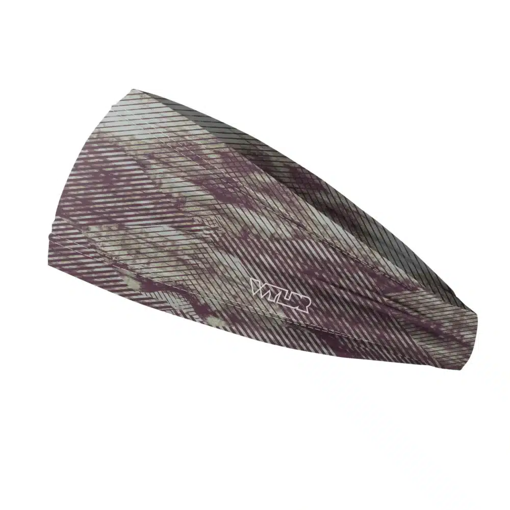 Side view of a headband that is 3 inches at the front and 1 inch in the back to show that it is tapered. the design is an abstract pattern. lines are used to create the illusion of mountain ridges. this is in the vine/celery color variant