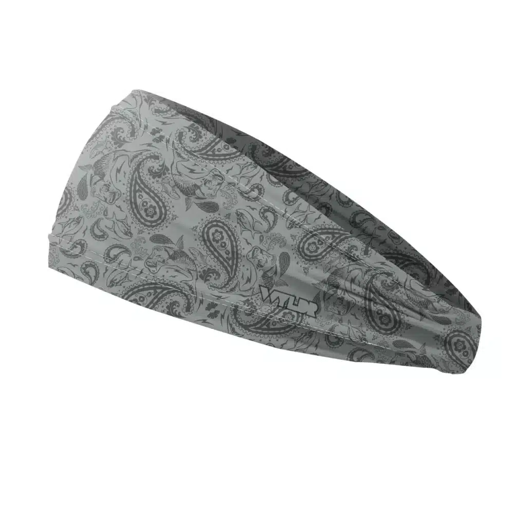 Side view of a headband that is 3 inches at the front and 1 inch in the back to show that it is tapered. traditional paisley elements have been replaced with different fish species. this design is available in a smoke/coal color variant