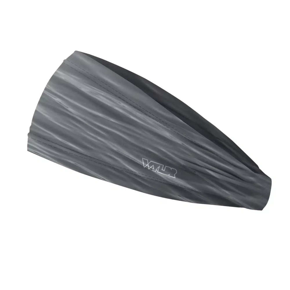 Side view of a headband that is 3 inches at the front and 1 inch in the back to show that it is tapered. The design is a ripple pattern featuring gray colors