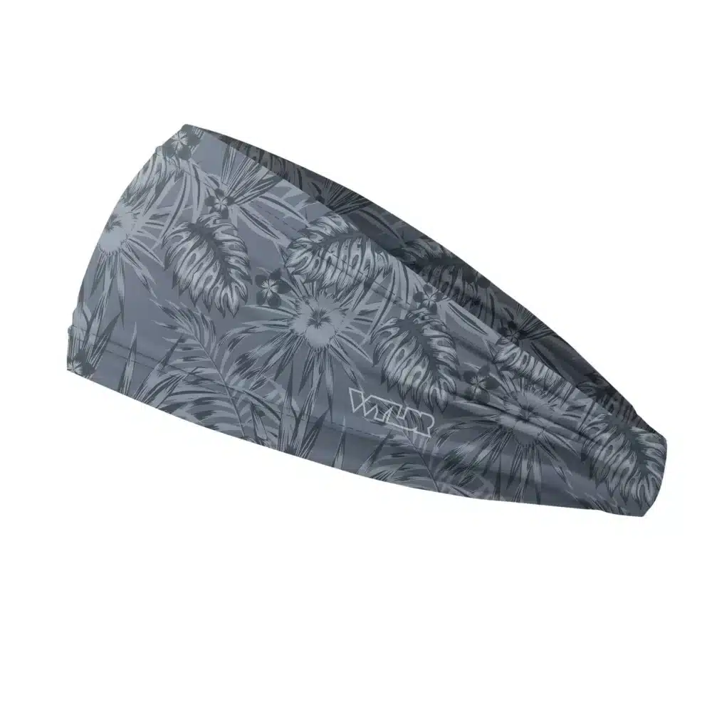 Side view of a headband that is 3 inches at the front and 1 inch in the back to show that it is tapered. The design is an abstract pattern. lines are used to create the illusion of tropical flowers and leaves on a solid color background. this is in the coal/lake color variant