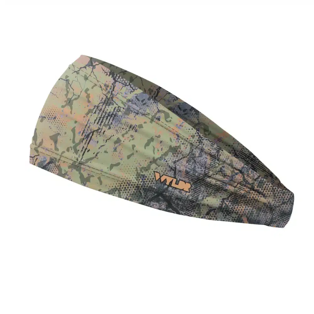Side view of a headband that is 3 inches at the front and 1 inch in the back to show that it is tapered. Abstract design in green with some purple and coral coloration created to mimic the colorful designs found on fish