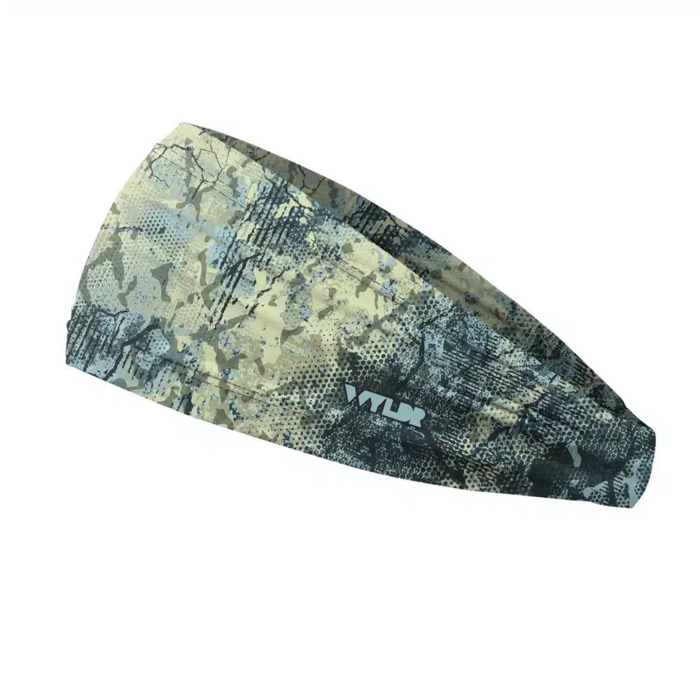 Side view of a headband that is 3 inches at the front and 1 inch in the back to show that it is tapered. Abstract design in light greens and blues created to mimic the colorful designs found on fish