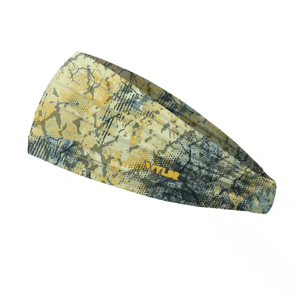 Side view of a headband that is 3 inches at the front and 1 inch in the back to show that it is tapered. Abstract design in yellows and blues created to mimic the colorful designs found on fish