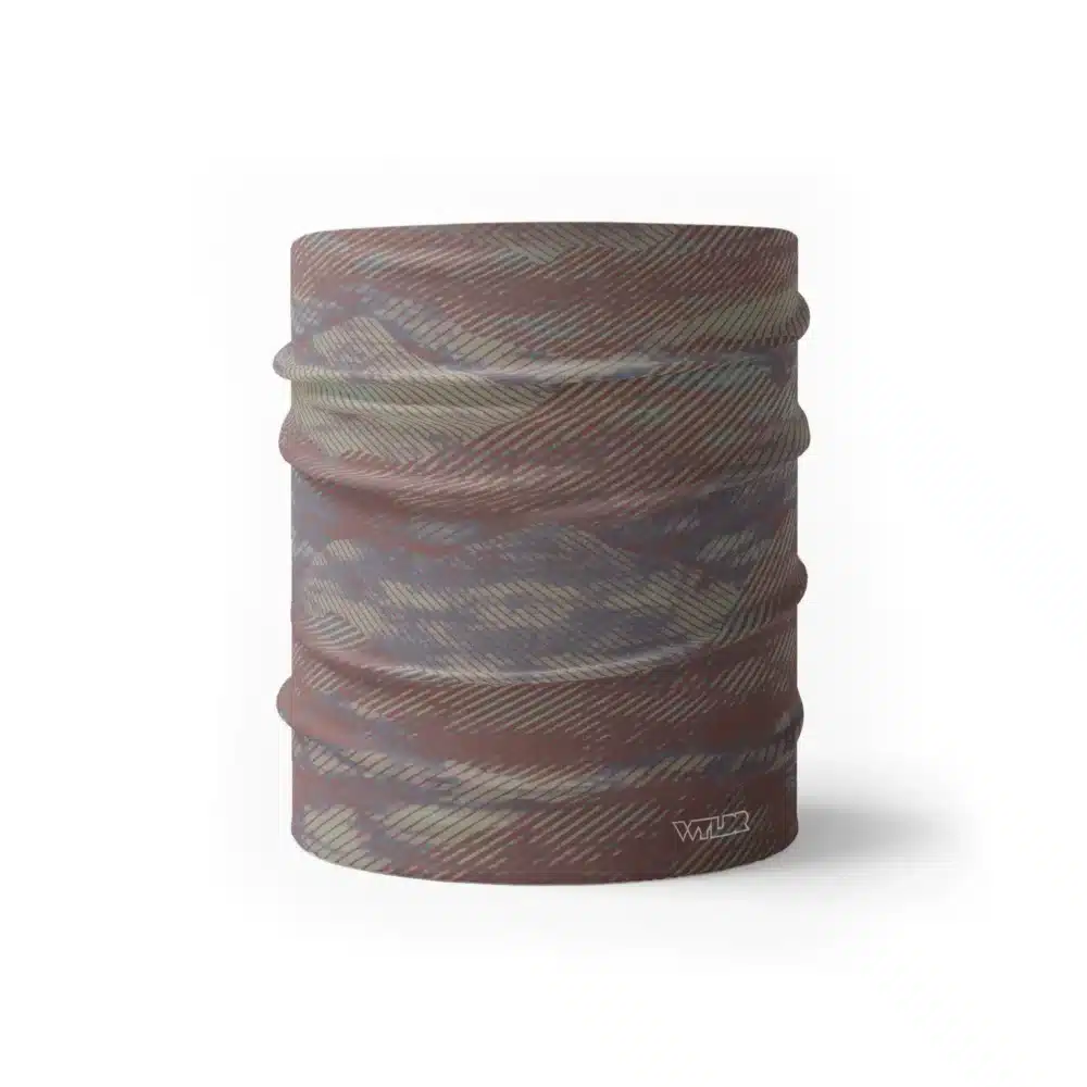 an image of a half neck gaiter in an abstract pattern. lines are used to create the illusion of mountain ridges. this is in the cedar/sage color variant