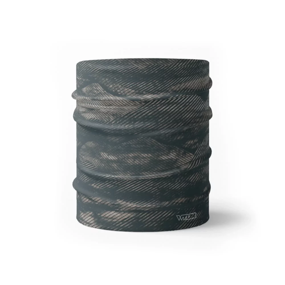 an image of a half neck gaiter in an abstract pattern. lines are used to create the illusion of mountain ridges. this is in the coal/hibiscus color variant