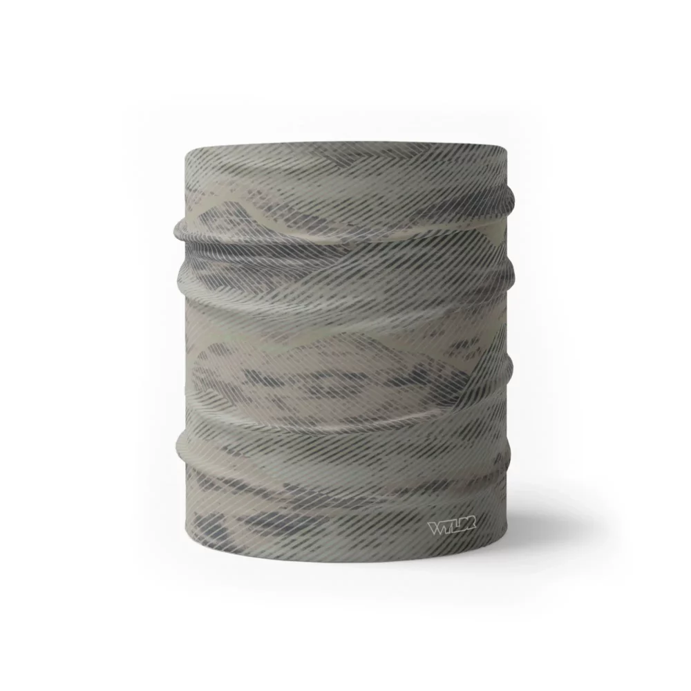 an image of a half neck gaiter in an abstract pattern. lines are used to create the illusion of mountain ridges. this is in the sage/dune color variant