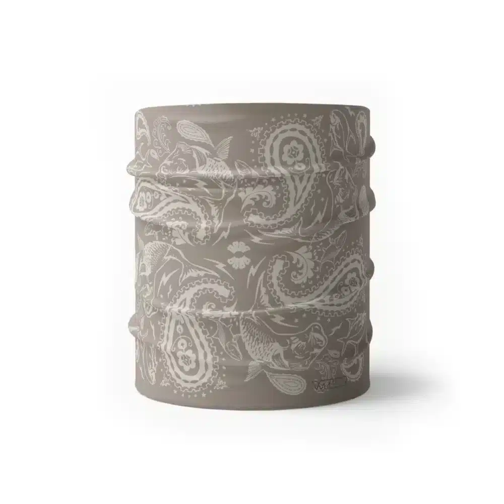an image of a half gaiter where paisley has been redesigned. traditional paisley elements have been replaced with different fish species. this design is available in a putty/dune color variant