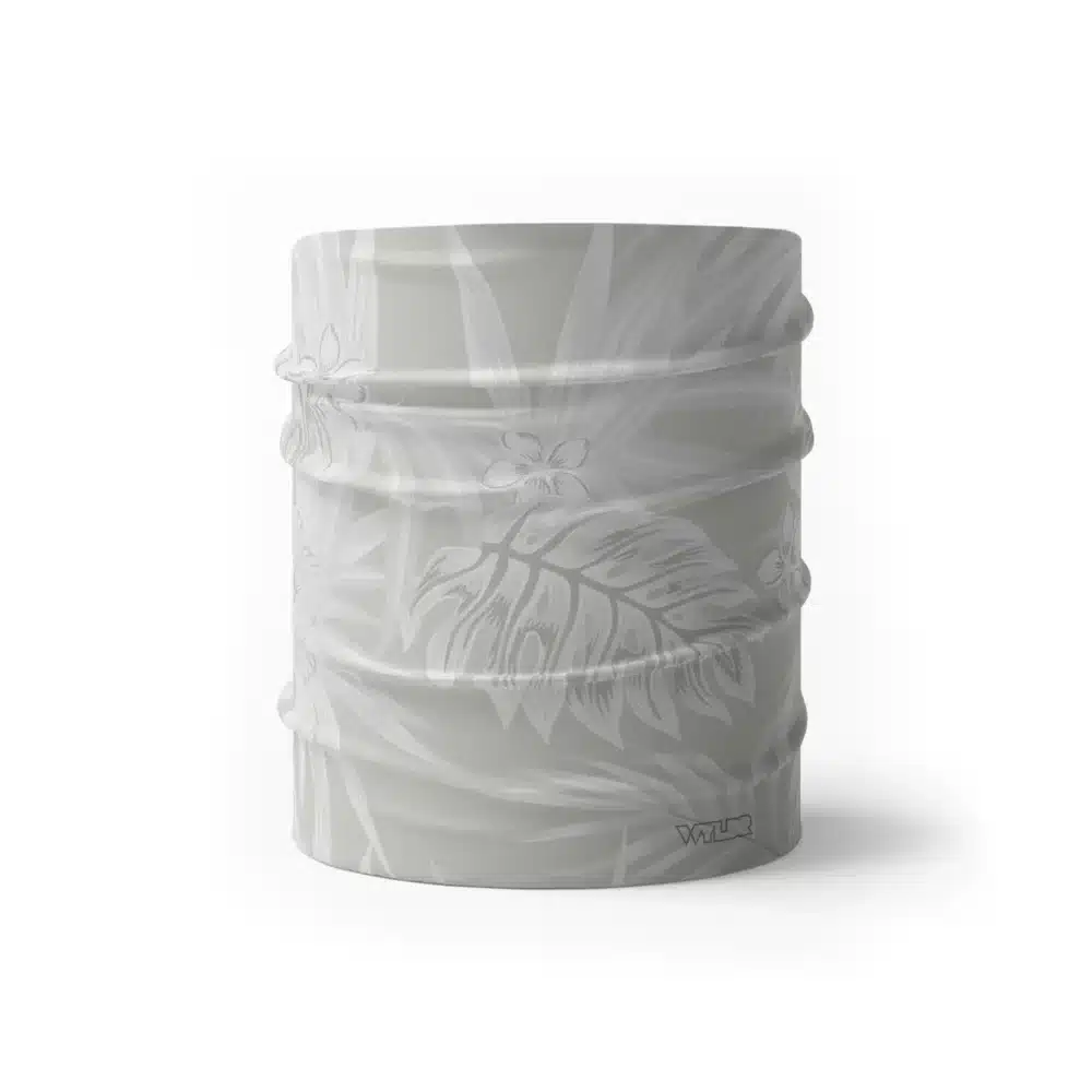 an image of a half size neck gaiter in an abstract pattern. lines are used to create the illusion of tropical flowers and leaves on a solid color background. this is in the dune/stone color variant