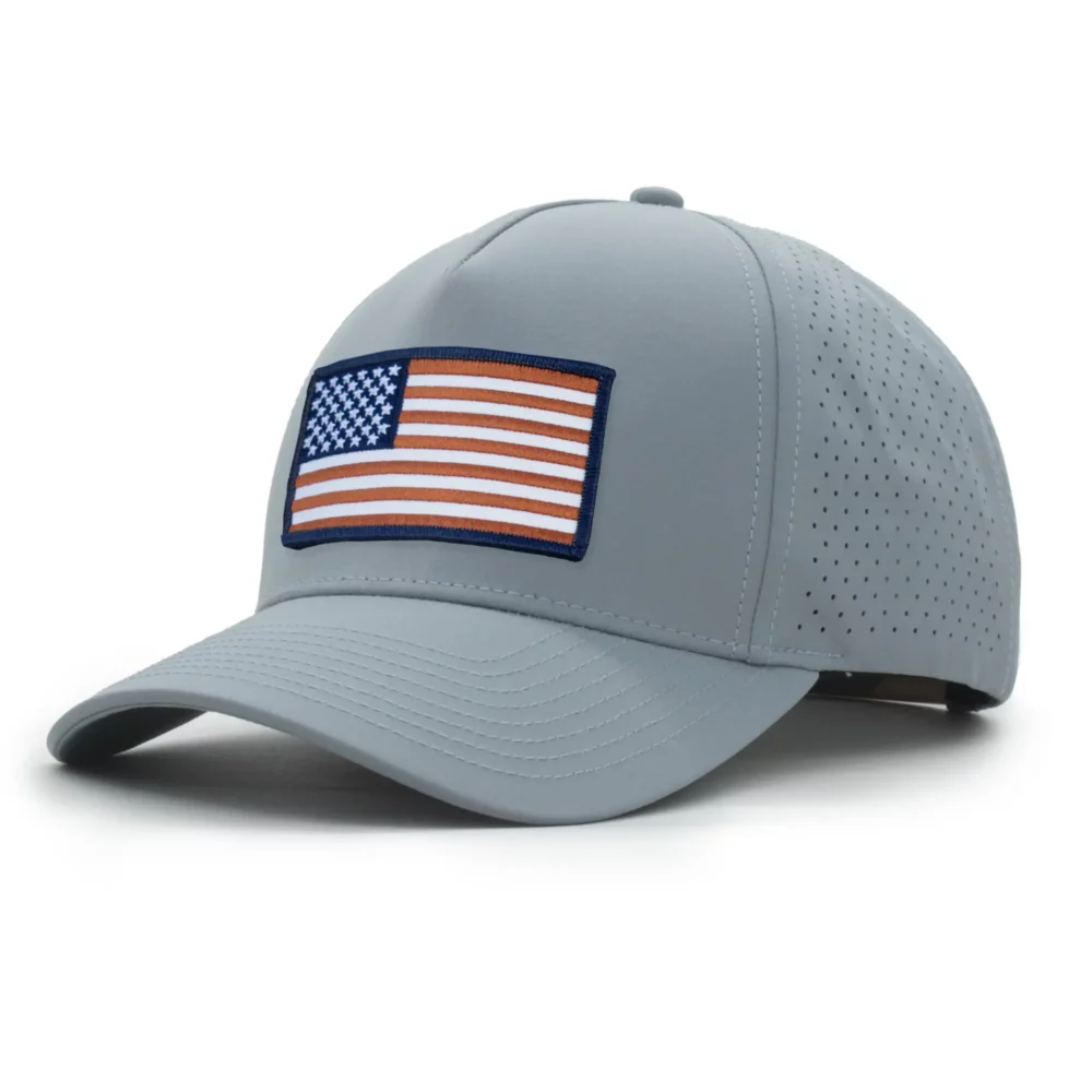 three-quarter view of a 5 panel, water resistant, floatable hat with an embroidered american flag patch. the hat is a light blue color.