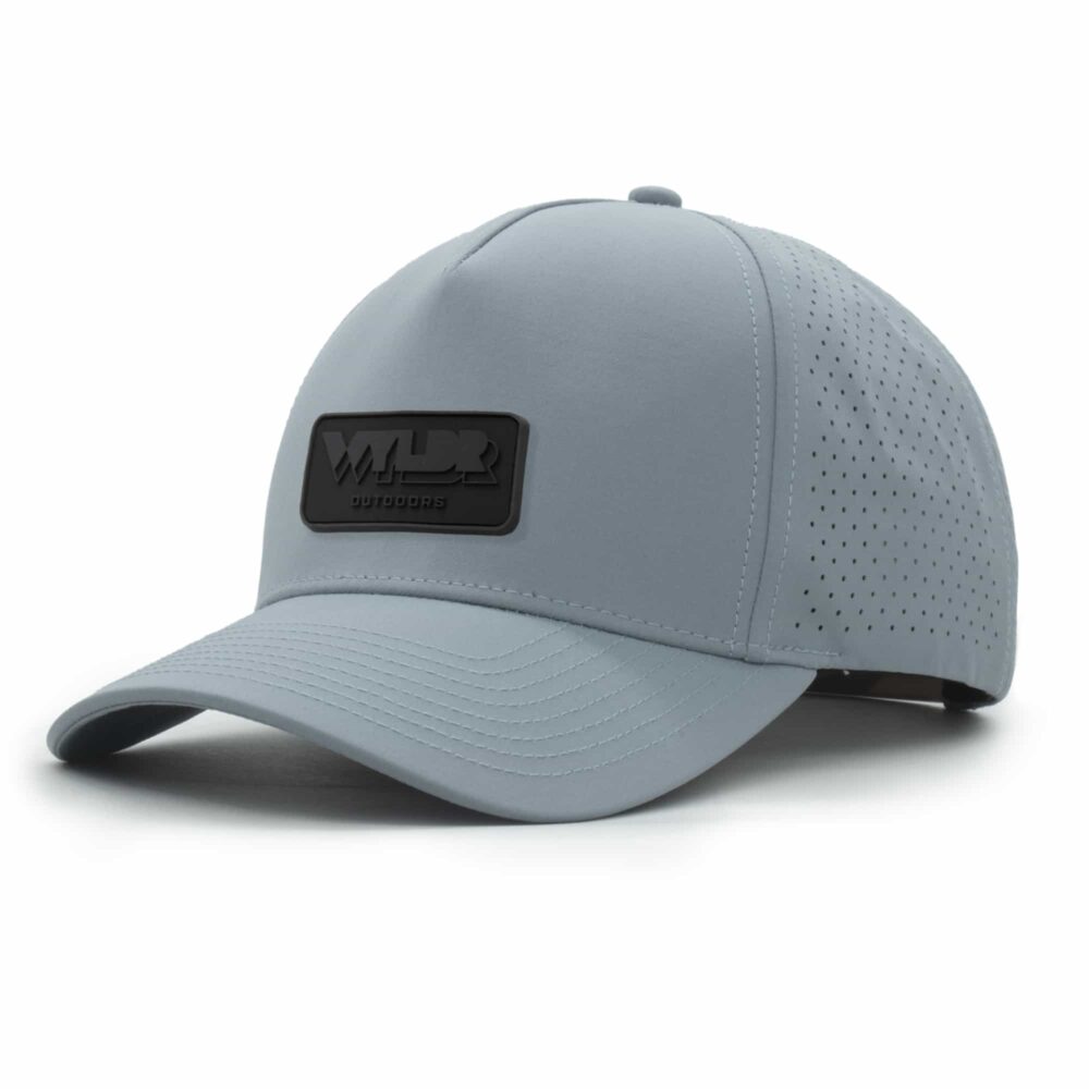 three-quarter view of a 5 panel, water resistant, floatable hat with a PVC patch. the patch is the brand name Wyldr contained in a rounded rectangle. the hat is light blue.