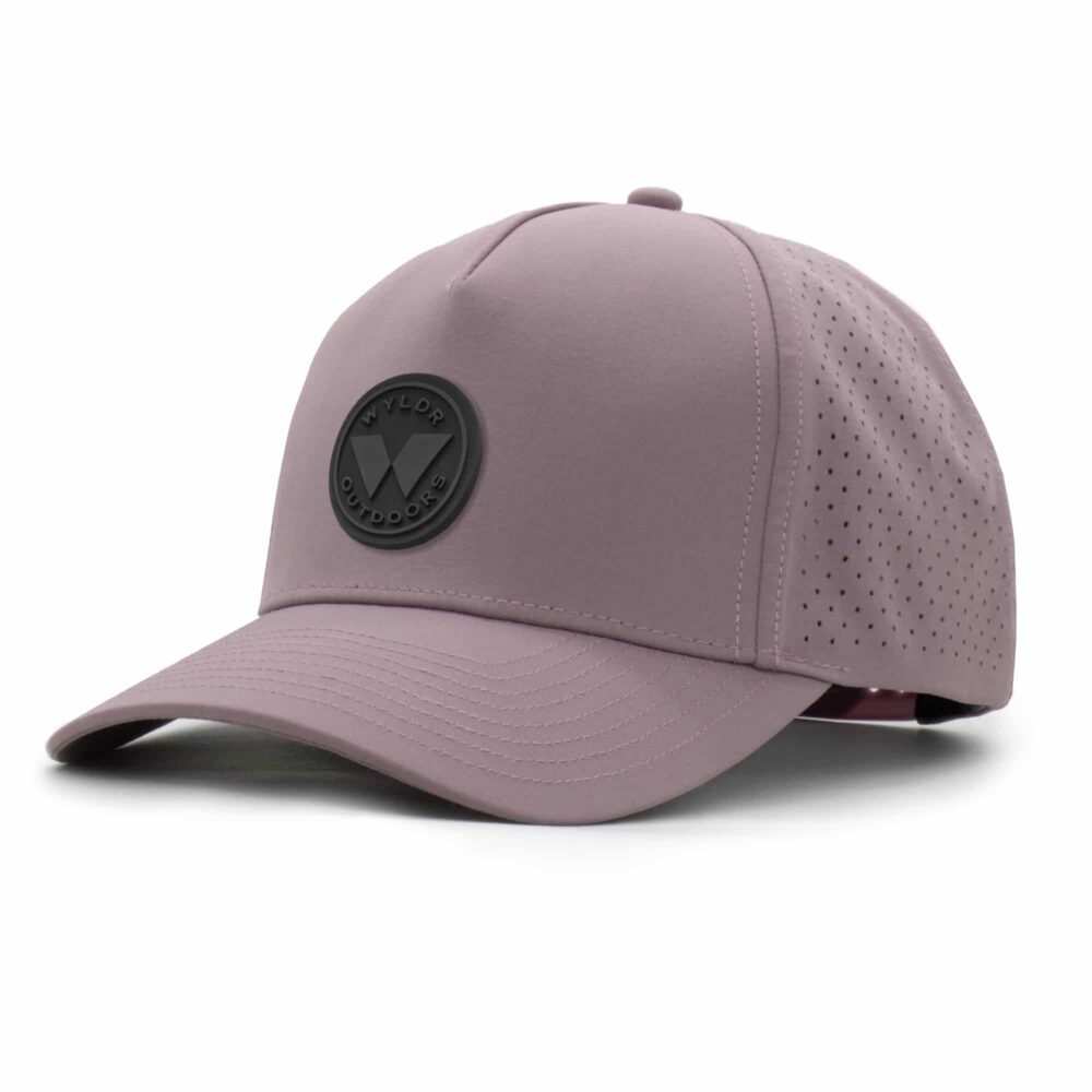 three-quarter view of a 5 panel, water resistant, floatable hat with a PVC patch. the patch is a round medallion featuring the letter W and the text Wyldr Outdoors. the hat is lilac purple