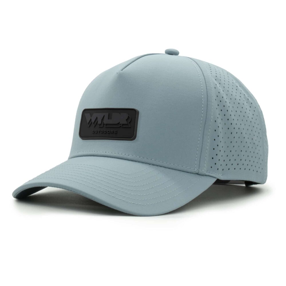 three-quarter view of a 5 panel, water resistant, floatable hat with a PVC patch. the patch is the brand name Wyldr contained in a rounded rectangle. the hat is light blue