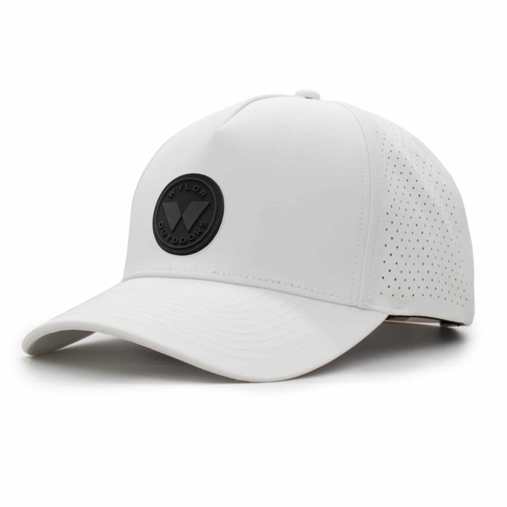 three-quarter view of a 5 panel, water resistant, floatable hat with a PVC patch. the patch is a round medallion featuring the letter W and the text Wyldr Outdoors. the hat is white