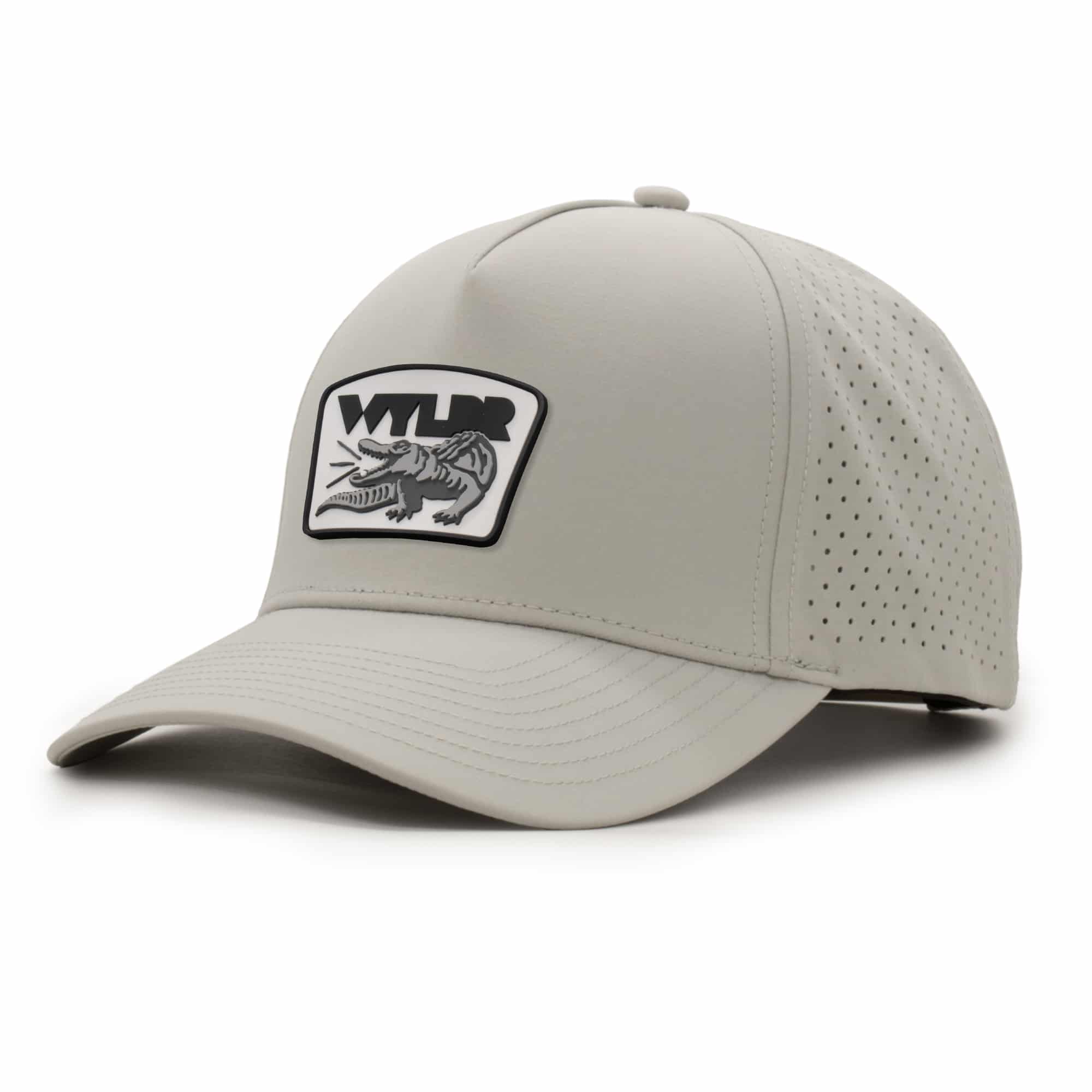 (RH) Ridge Hat | Stone - Gator three-quarter view of a 5 panel, water resistant, floatable hat with a PVC patch. the patch is a gator catching a golf ball in its mouth and features the brand name, Wyldr. the hat is light tan