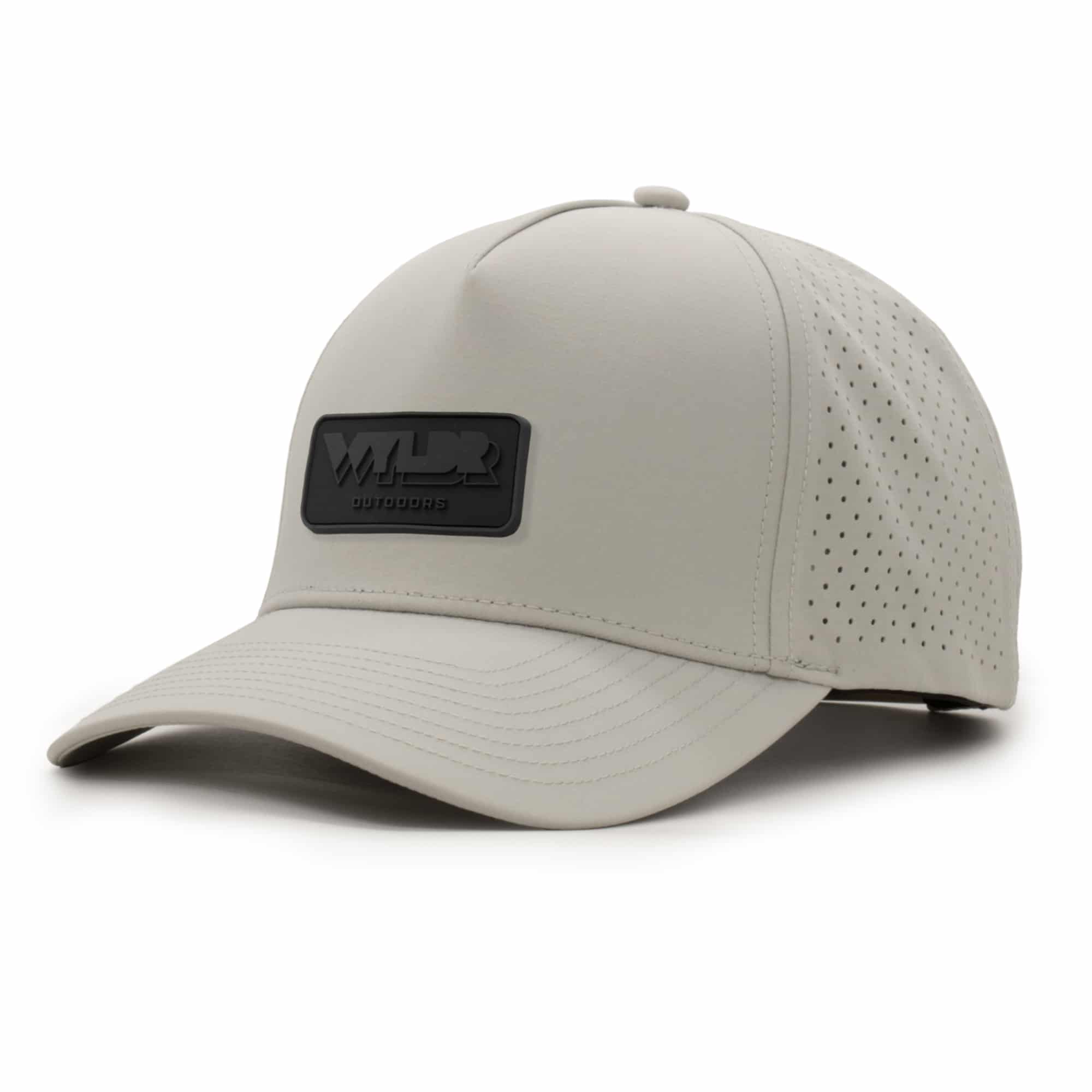 three-quarter view of a 5 panel, water resistant, floatable hat with a PVC patch. the patch is the brand name Wyldr contained in a rounded rectangle. the hat is light tan.