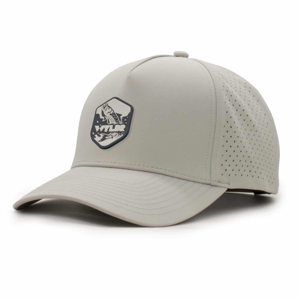 three-quarter view of a 5 panel, water resistant, floatable hat with a PVC patch. the patch is of a tarpon splashing out of the water and has the brand name Wyldr over it. the hat is light tan