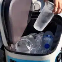 an image of a cooler filled with ice, water bottles and glass inserts for the DUUN tumbler.