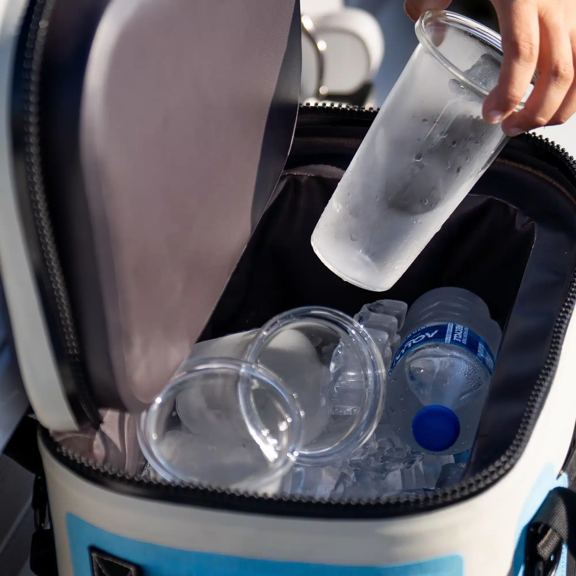 an image of a cooler filled with ice, water bottles and glass inserts for the DUUN tumbler.